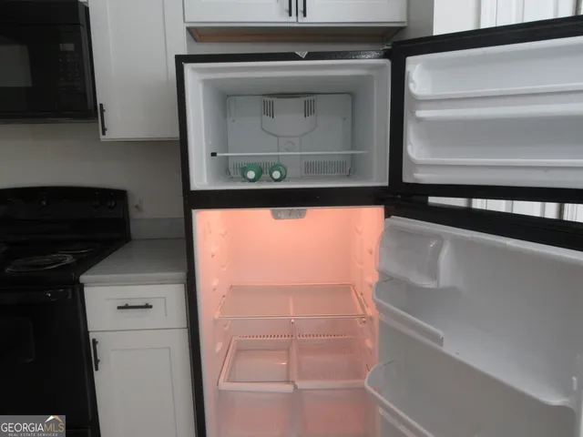 a stove top oven sitting inside of a kitchen