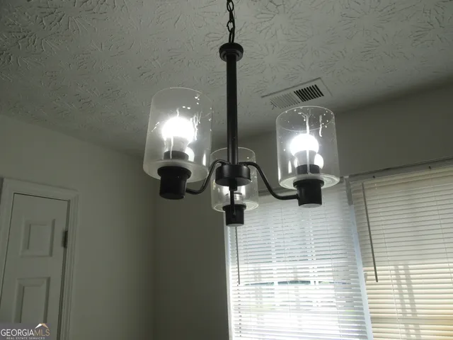 a view of a chandelier and a wooden floor in a room