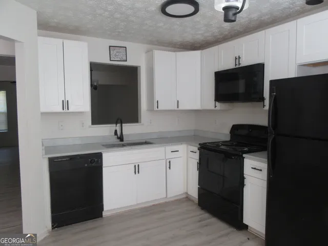 a kitchen with a sink stainless steel appliances and cabinets