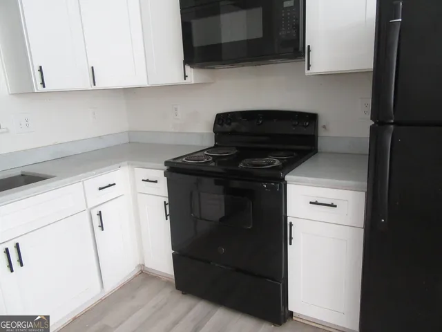 a kitchen with a stove and a microwave