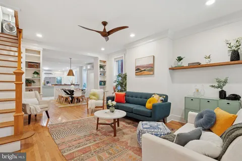 a living room with furniture and kitchen view