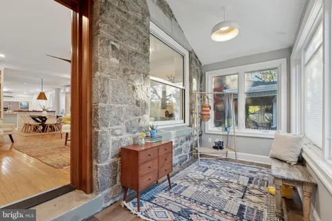 a living room with furniture and large windows
