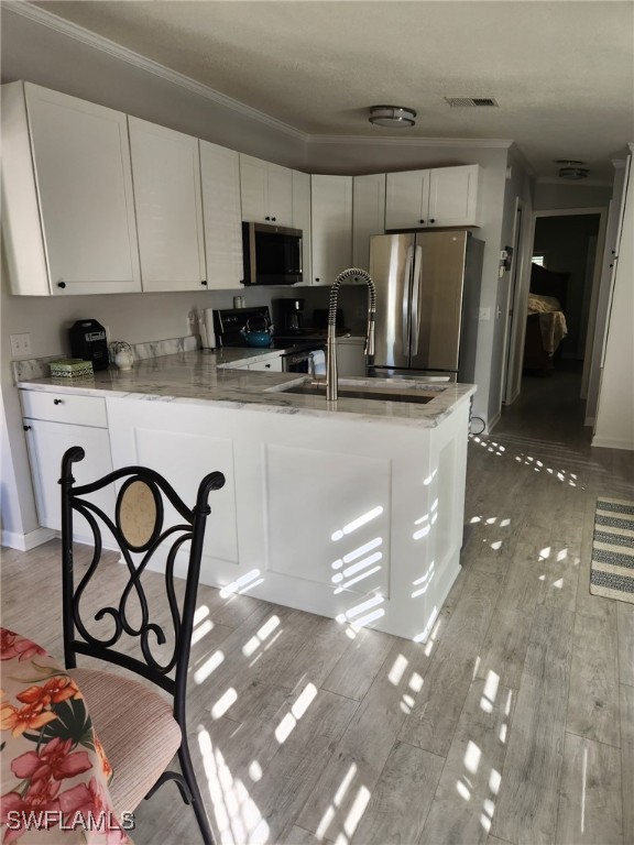 10823 Ani Circle Estero, FL 33928 - Photo 11 of 31 a kitchen with stainless steel appliances granite countertop a refrigerator a stove a sink and white cabinets with wooden floor
