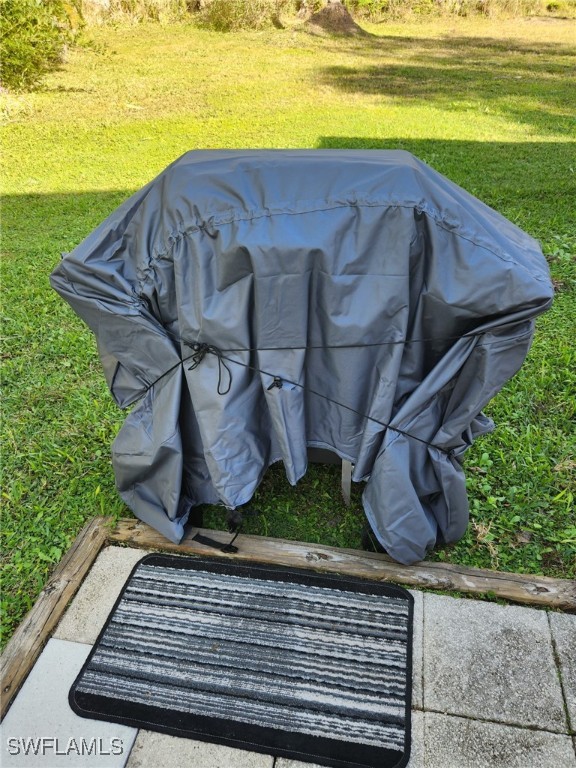 10823 Ani Circle Estero, FL 33928 - Photo 20 of 31 a view of a backyard with lawn chairs under an umbrella