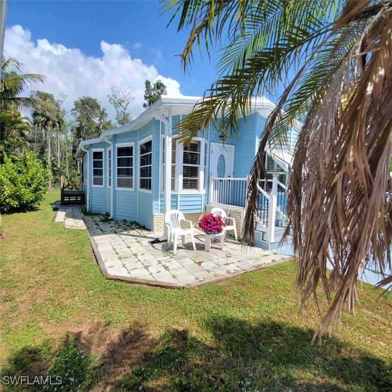 10823 Ani Circle Estero, FL 33928 - Photo 2 of 31 a backyard of a house with table and chairs