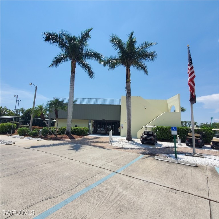 10823 Ani Circle Estero, FL 33928 - Photo 24 of 31 a yellow house with palm tree in front of it