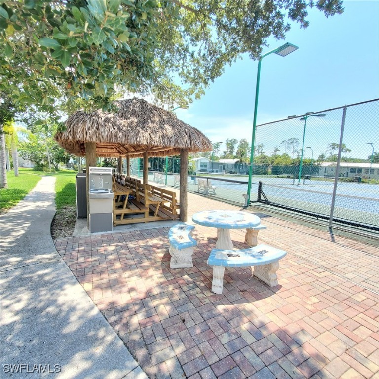 10823 Ani Circle Estero, FL 33928 - Photo 27 of 31 a view of a patio with a table chairs and a fire pit