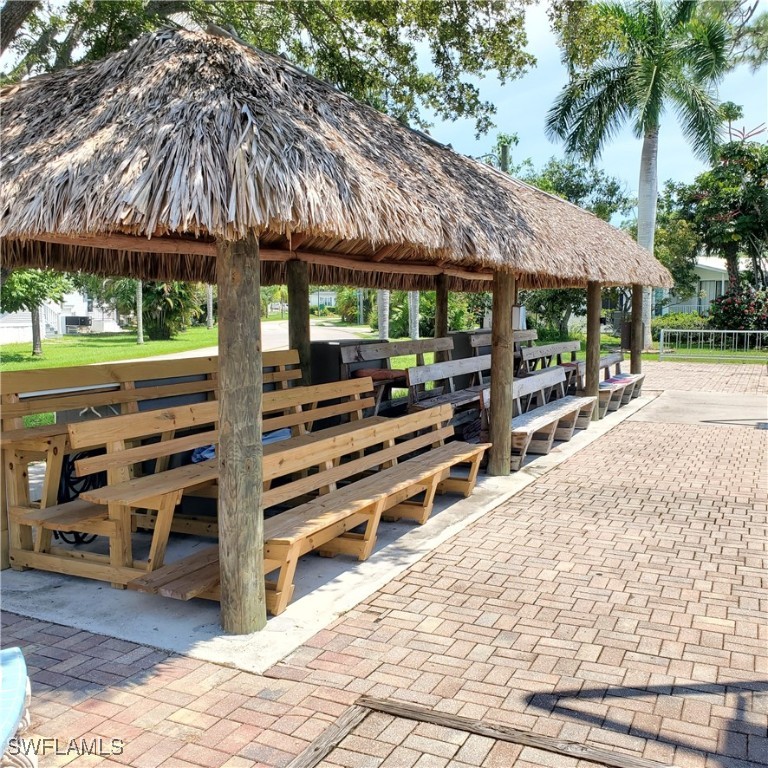 10823 Ani Circle Estero, FL 33928 - Photo 28 of 31 a view of a backyard with a patio and wooden fence