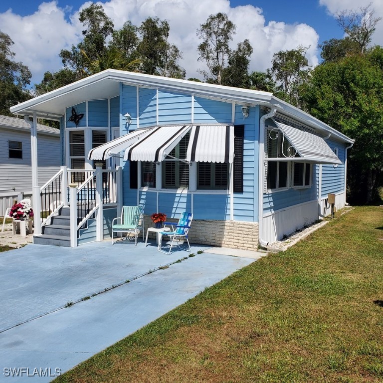 10823 Ani Circle Estero, FL 33928 - Photo 4 of 31 a view of a house with a patio and a yard
