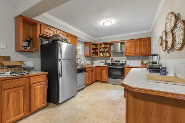 a kitchen with granite countertop stainless steel appliances a refrigerator a stove top oven a sink and dishwasher