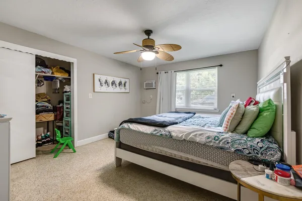 a bedroom with a bed and a chandelier