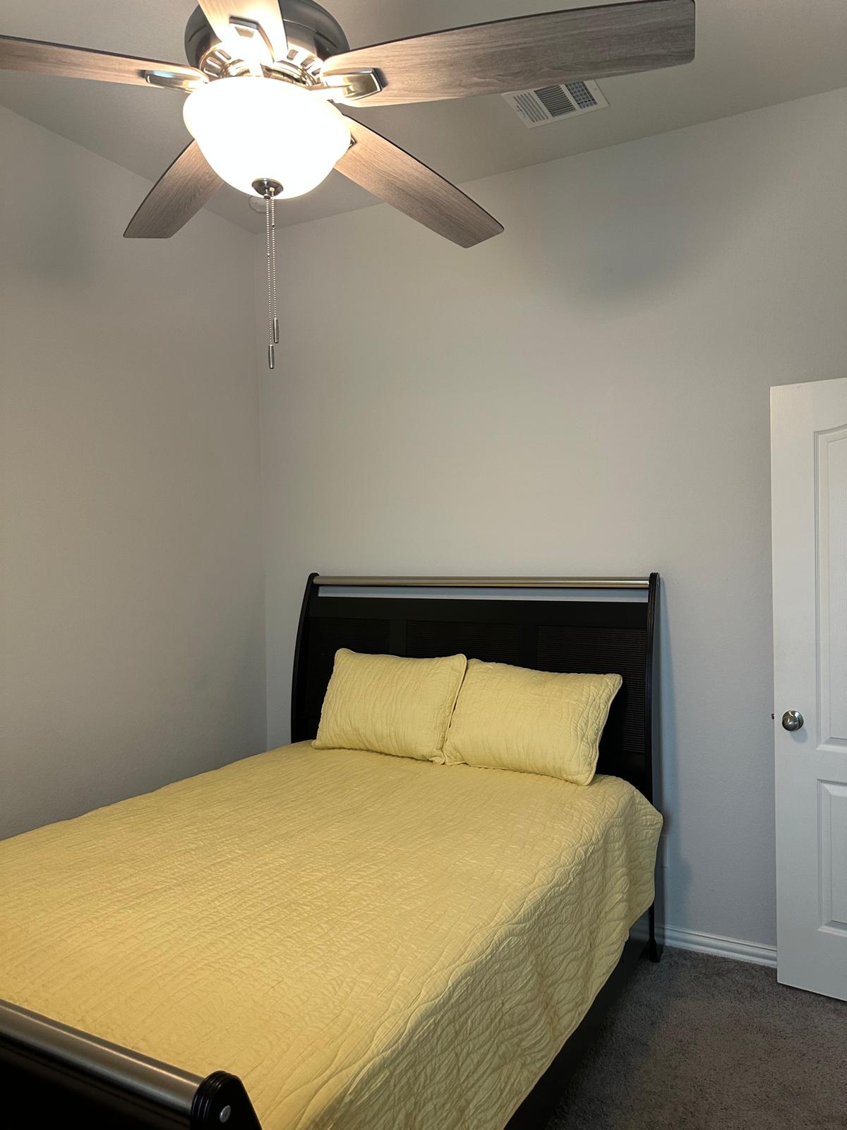862 Leadtree Loop Buda, TX 78610 - Photo 30 of 40 a bed sitting in a bedroom next to a window