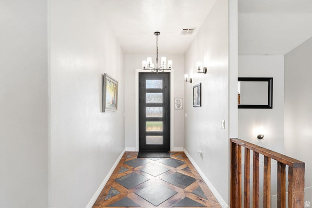7776 Wagon Road East St. George, UT 84770 - Photo 6 of 76 Entrance foyer featuring a chandelier and inlaid floor details