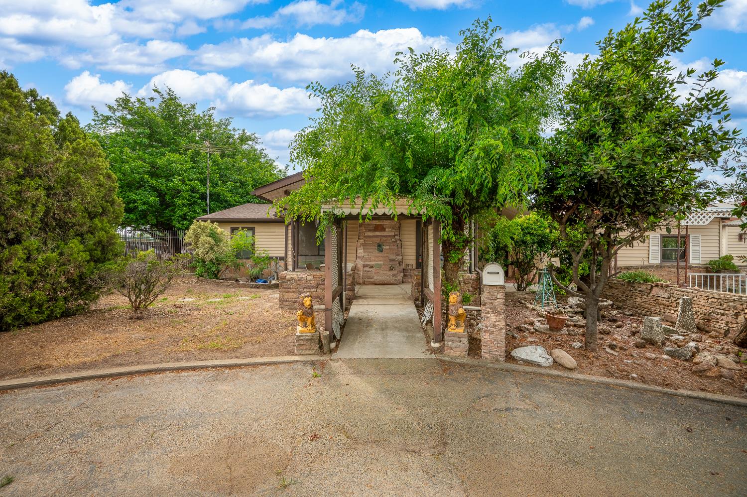 13230 4th Street Hickman, CA 95323 - Photo 25 of 54 front view of a house with a tree in front of it
