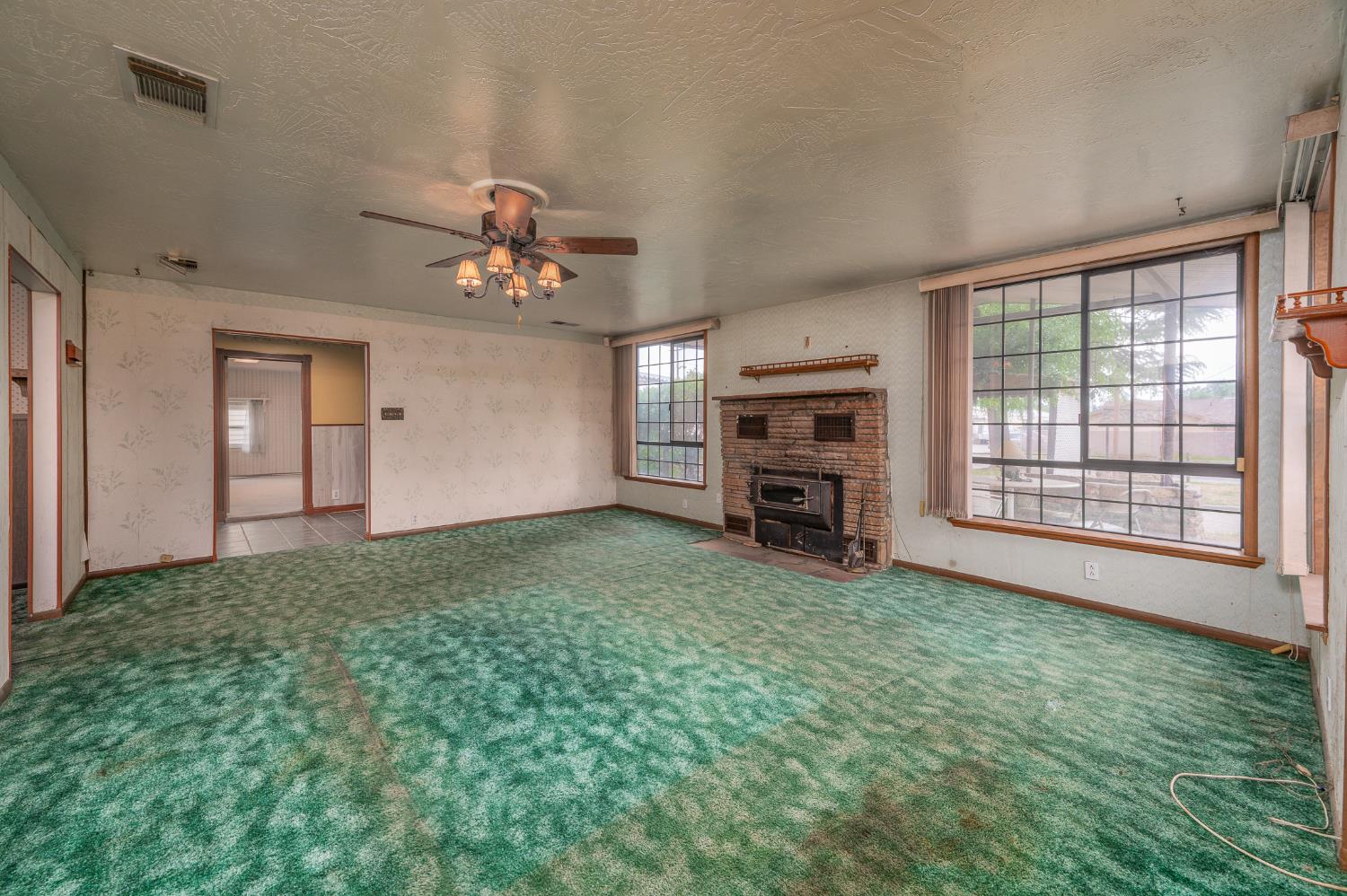 13230 4th Street Hickman, CA 95323 - Photo 28 of 54 a view of a livingroom with a cabinet a fireplace and a window