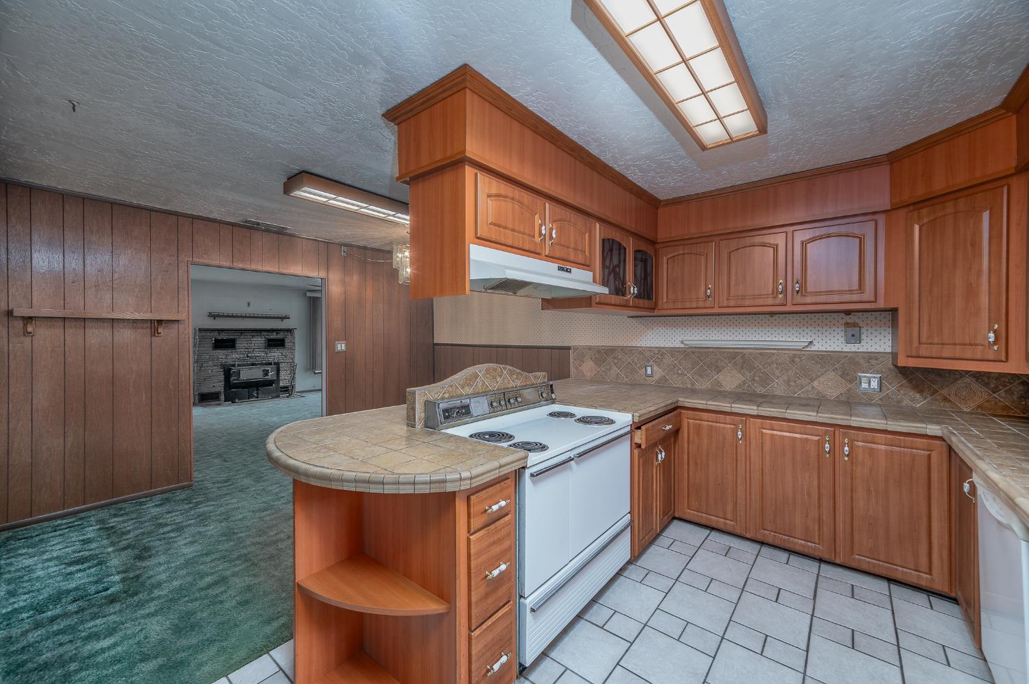 13230 4th Street Hickman, CA 95323 - Photo 31 of 54 a kitchen with stainless steel appliances granite countertop a sink stove and cabinets