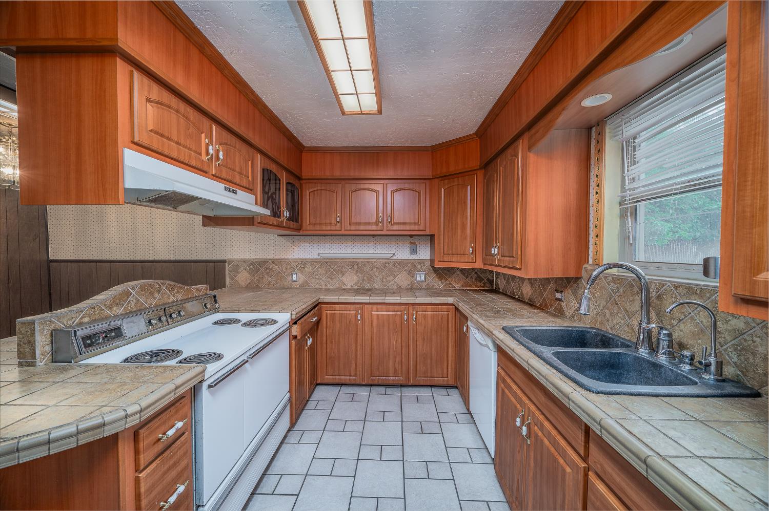 13230 4th Street Hickman, CA 95323 - Photo 32 of 54 a kitchen with a sink stove top oven and cabinets