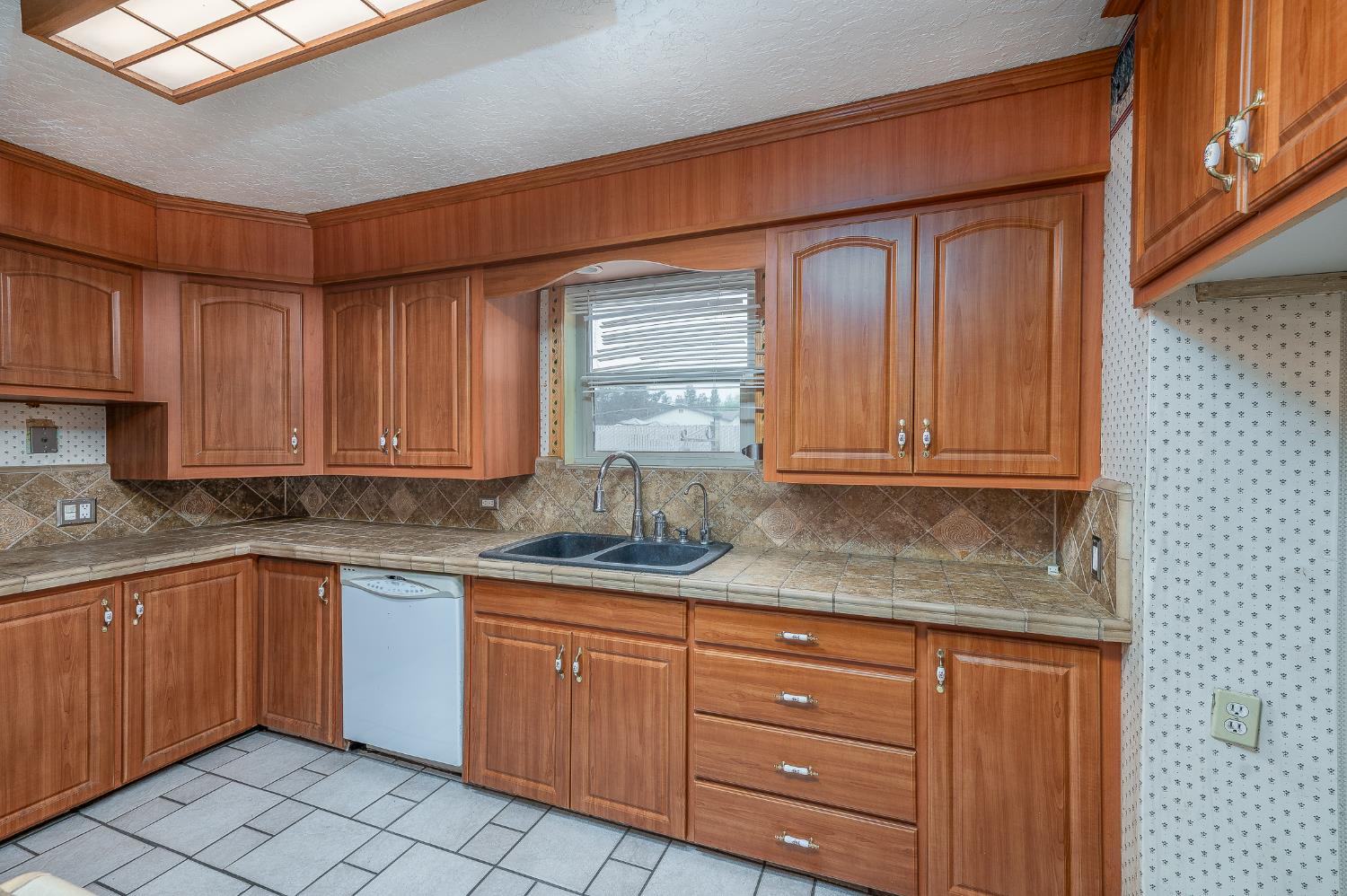 13230 4th Street Hickman, CA 95323 - Photo 33 of 54 a kitchen with granite countertop wooden cabinets stainless steel appliances a sink and a window