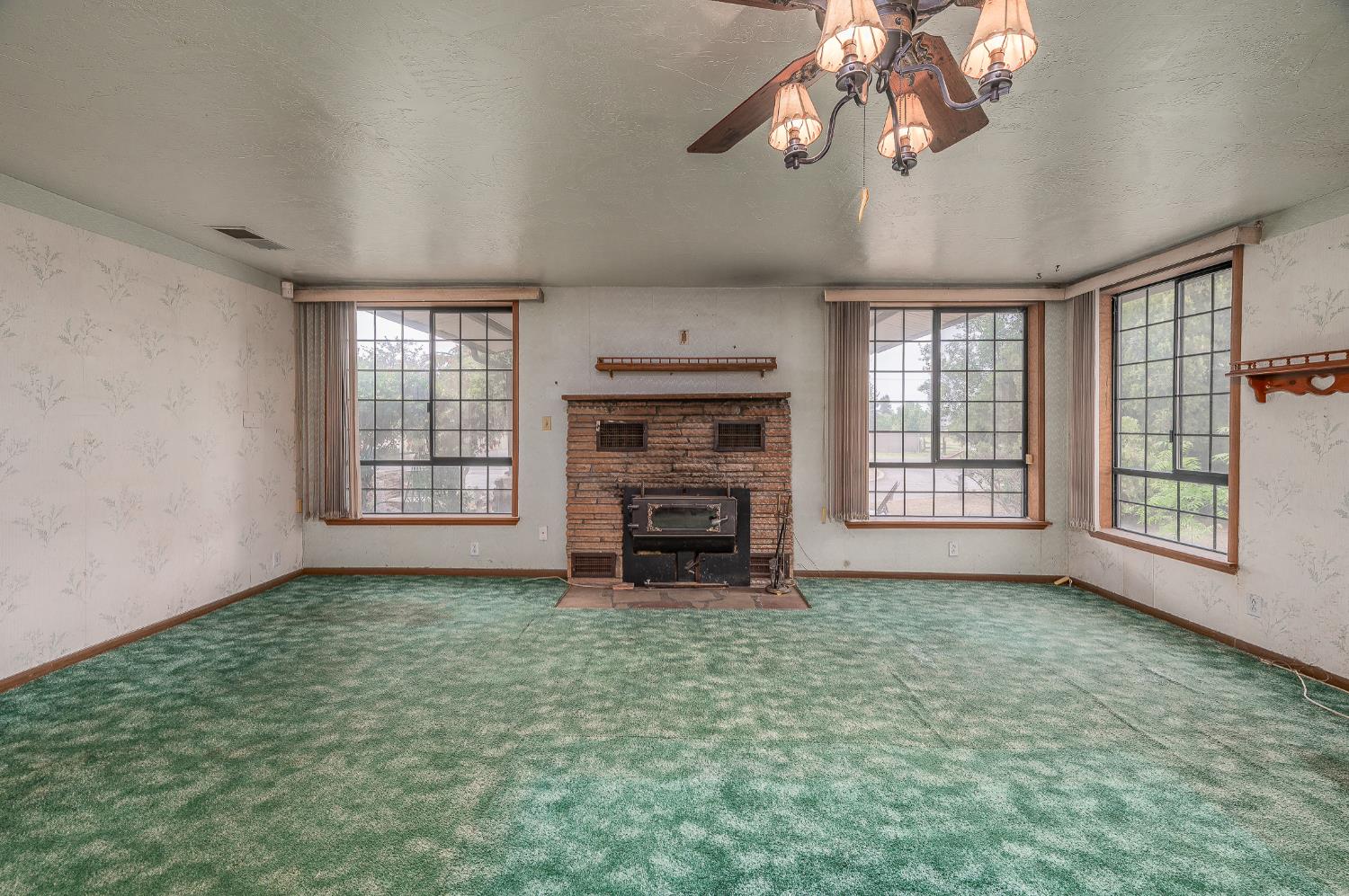 13230 4th Street Hickman, CA 95323 - Photo 41 of 54 an empty room with windows fireplace and cabinet