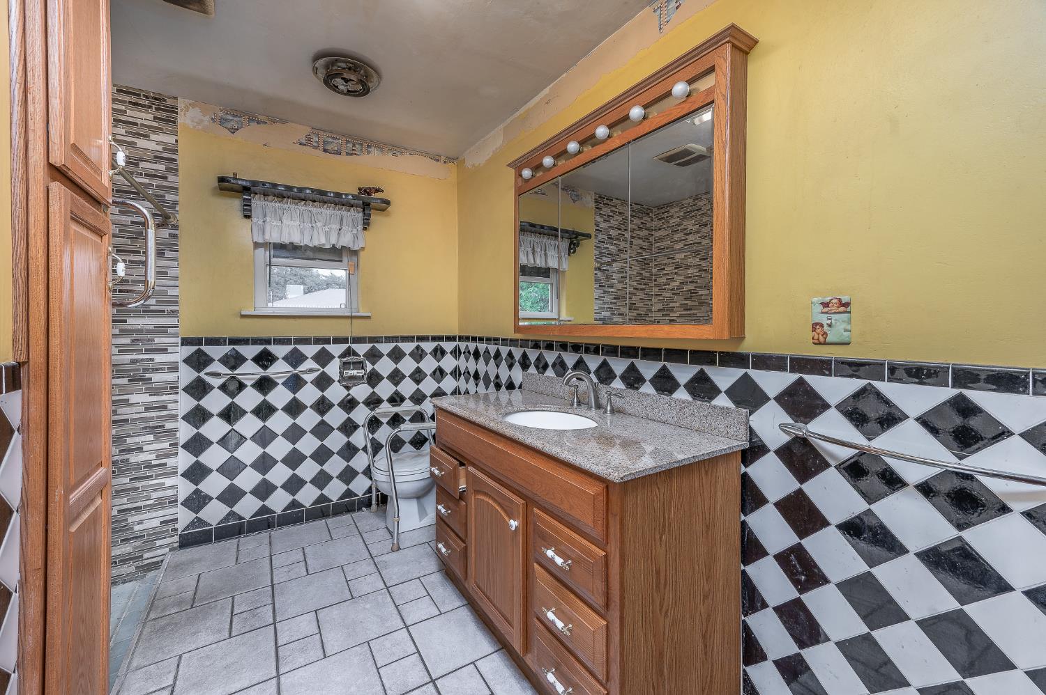 13230 4th Street Hickman, CA 95323 - Photo 49 of 54 a bathroom with a granite countertop sink and a mirror