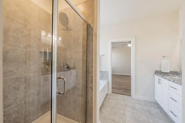 a bathroom with a granite countertop shower mirror and a sink
