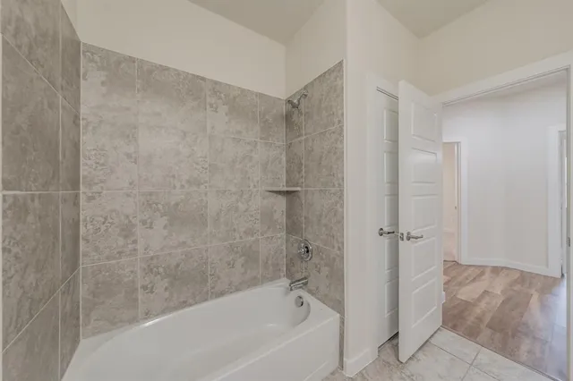a bathroom with a bathtub and shower