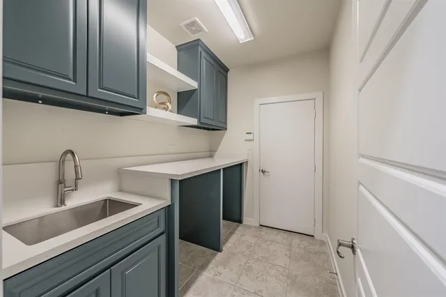 a kitchen with stainless steel appliances granite countertop a sink and cabinets