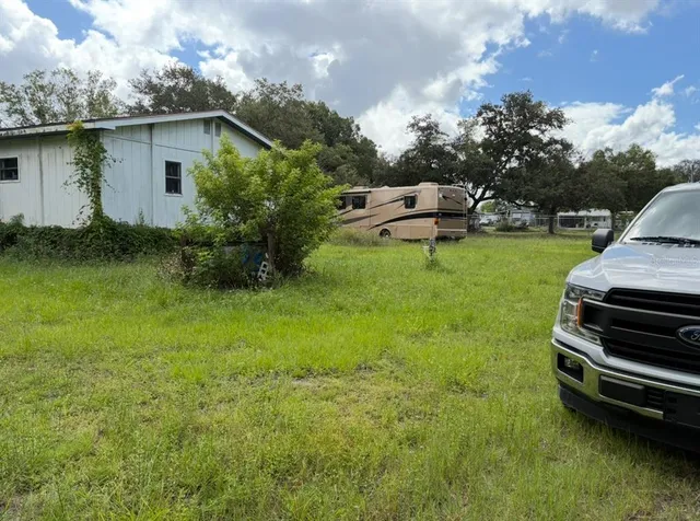 a view of a backyard with plants and a garden