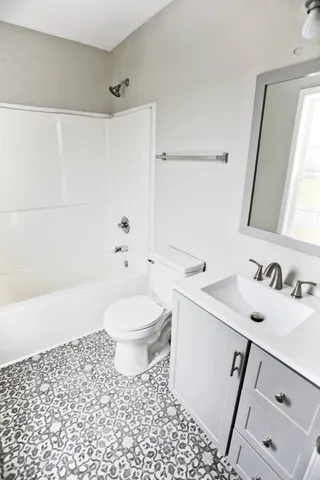 a bathroom with a sink a toilet and a shower