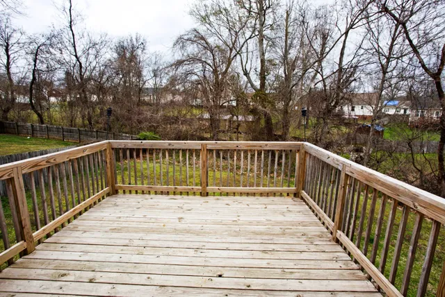 a balcony with view of trees in front of it