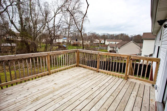 a view of balcony with wooden floor and fence