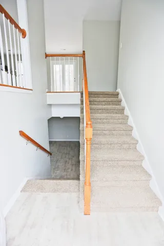 a view of staircase with white walls and a window