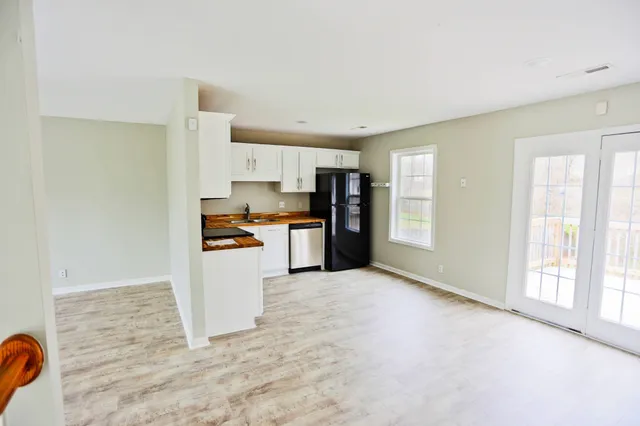a kitchen with stainless steel appliances granite countertop a refrigerator and a stove top oven