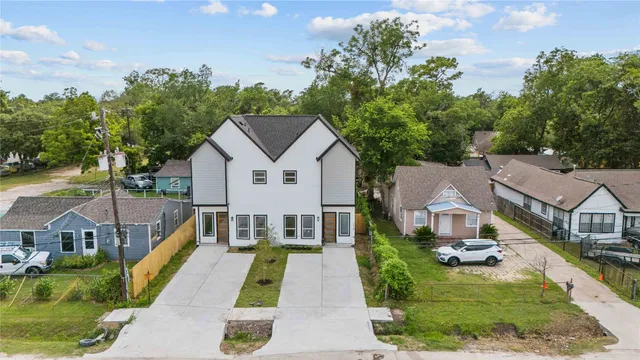 a aerial view of a house with swimming pool in front of it
