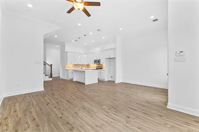 a view of kitchen with refrigerator microwave and stove