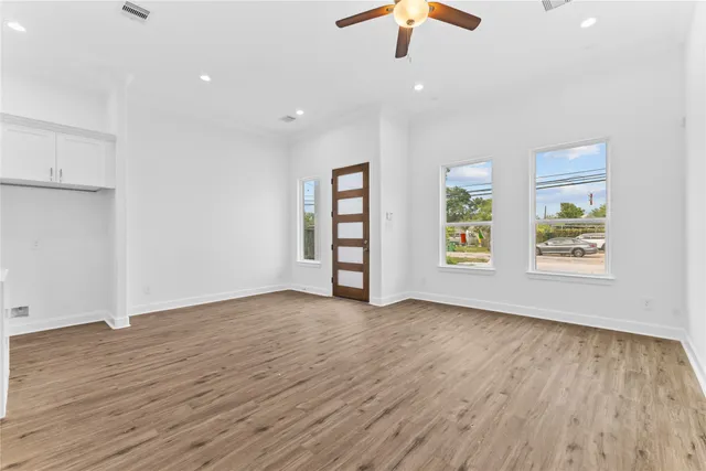 wooden floor in an empty room with a window
