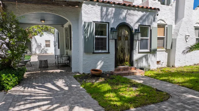 a bedroom with a bed a couch and dresser next to a window