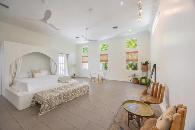 a living room with furniture a desk and chair with wooden floor