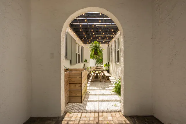 a bedroom with a bed and a large window