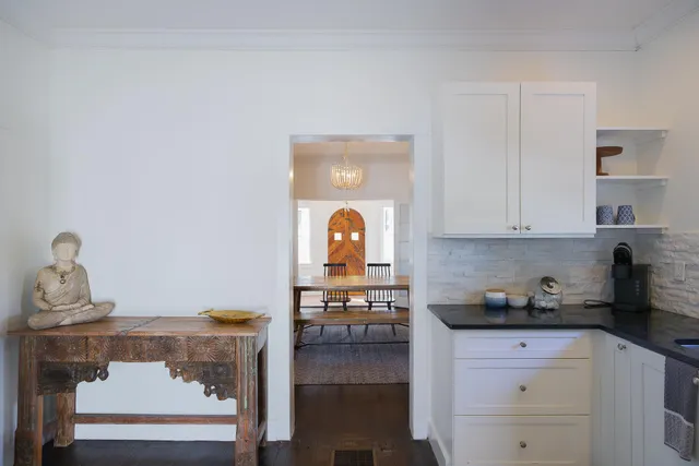 a dining room with furniture and a potted plant