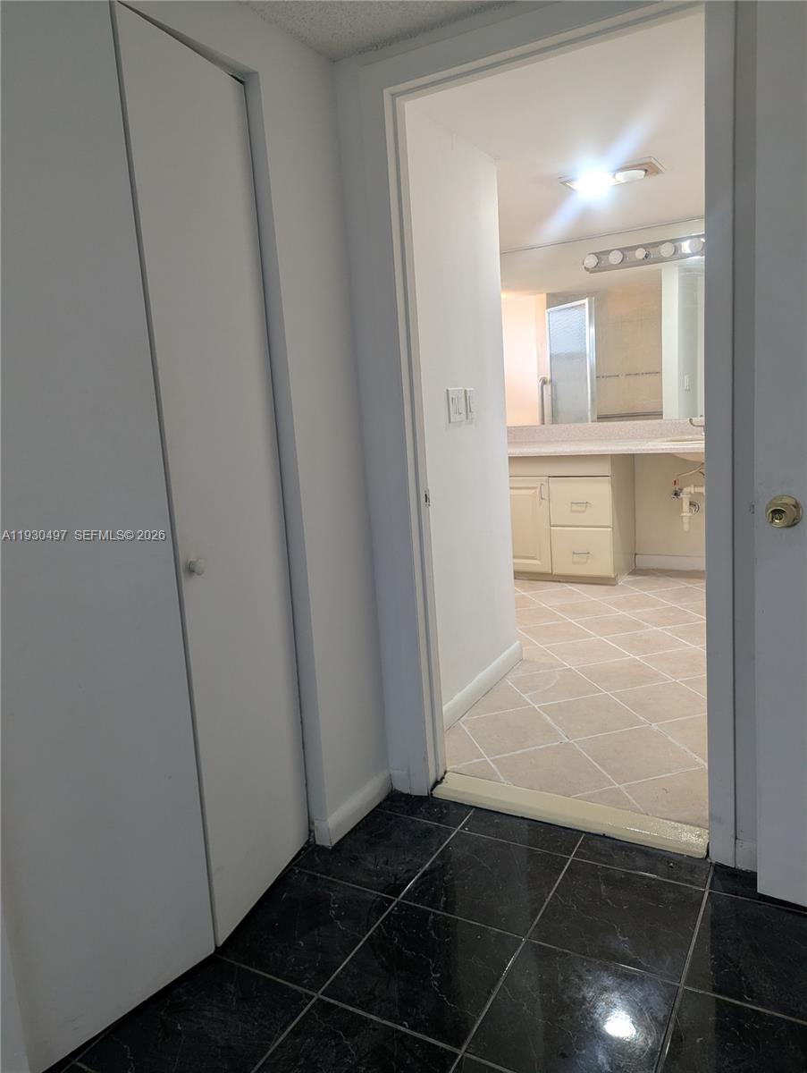601 Ives Dairy Road, Unit 4058 Miami, FL 33179 - Photo 12 of 21 a bathroom with a glass shower door