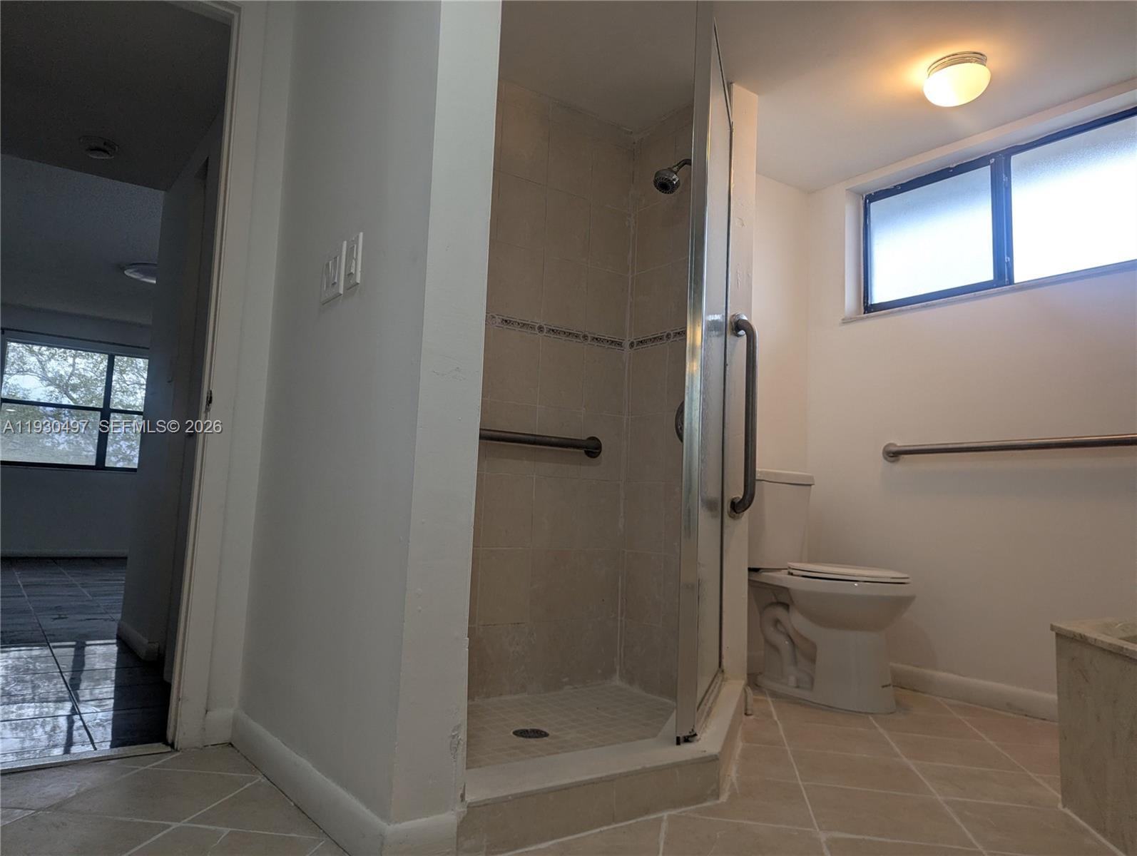 601 Ives Dairy Road, Unit 4058 Miami, FL 33179 - Photo 13 of 21 a bathroom with a toilet and a shower