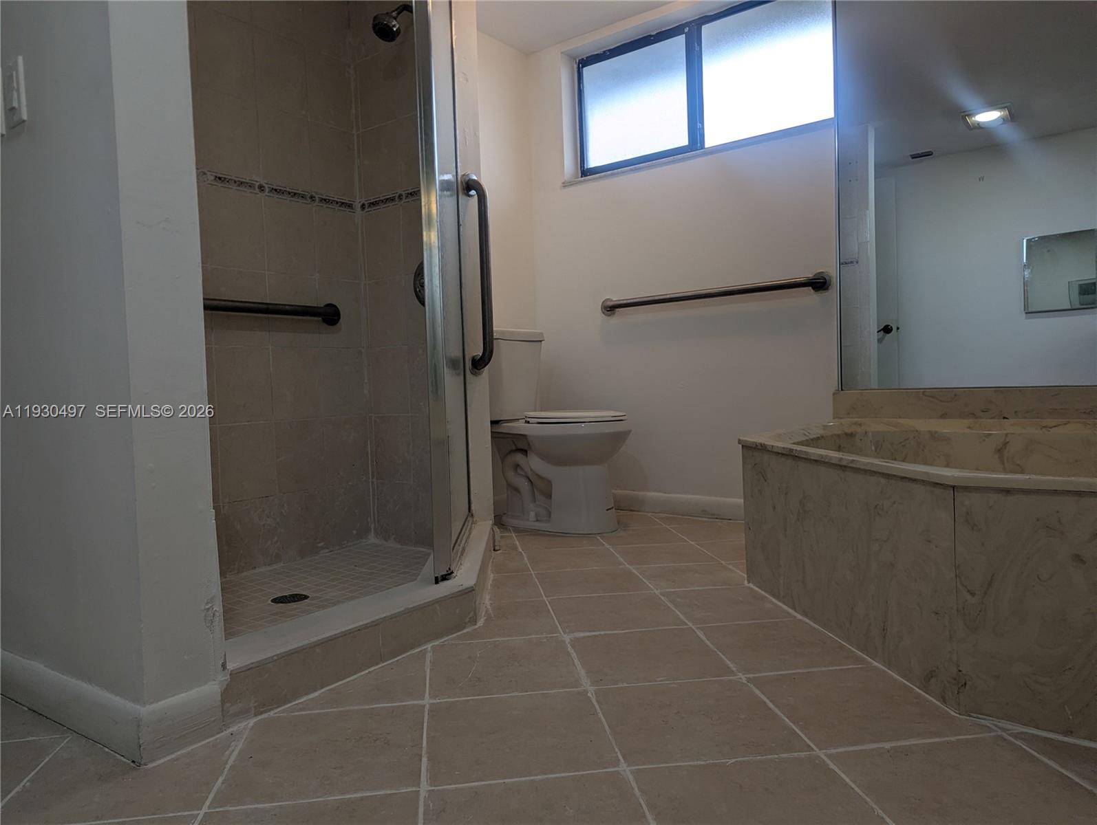 601 Ives Dairy Road, Unit 4058 Miami, FL 33179 - Photo 16 of 21 a bathroom with a shower and a toilet