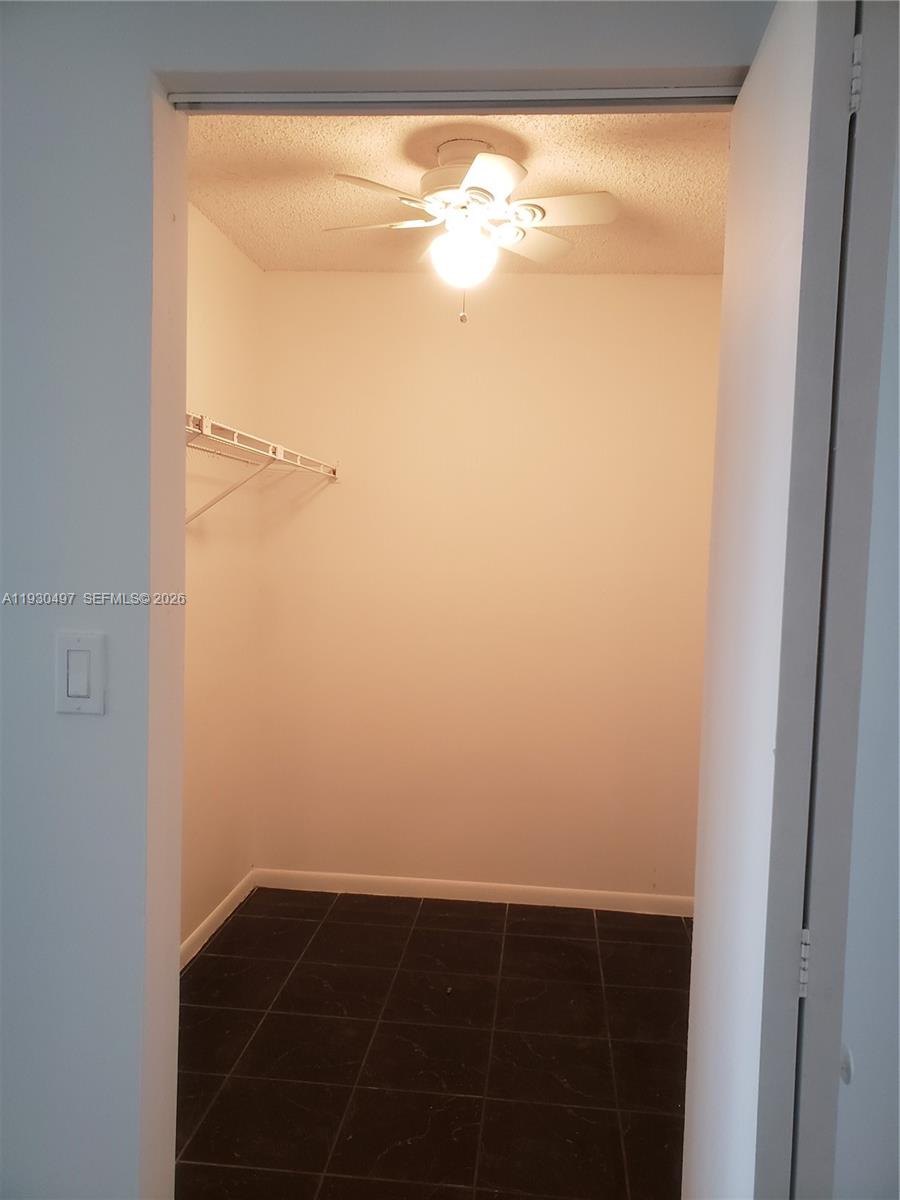 601 Ives Dairy Road, Unit 4058 Miami, FL 33179 - Photo 7 of 21 a view of a small space with wooden floor and a window