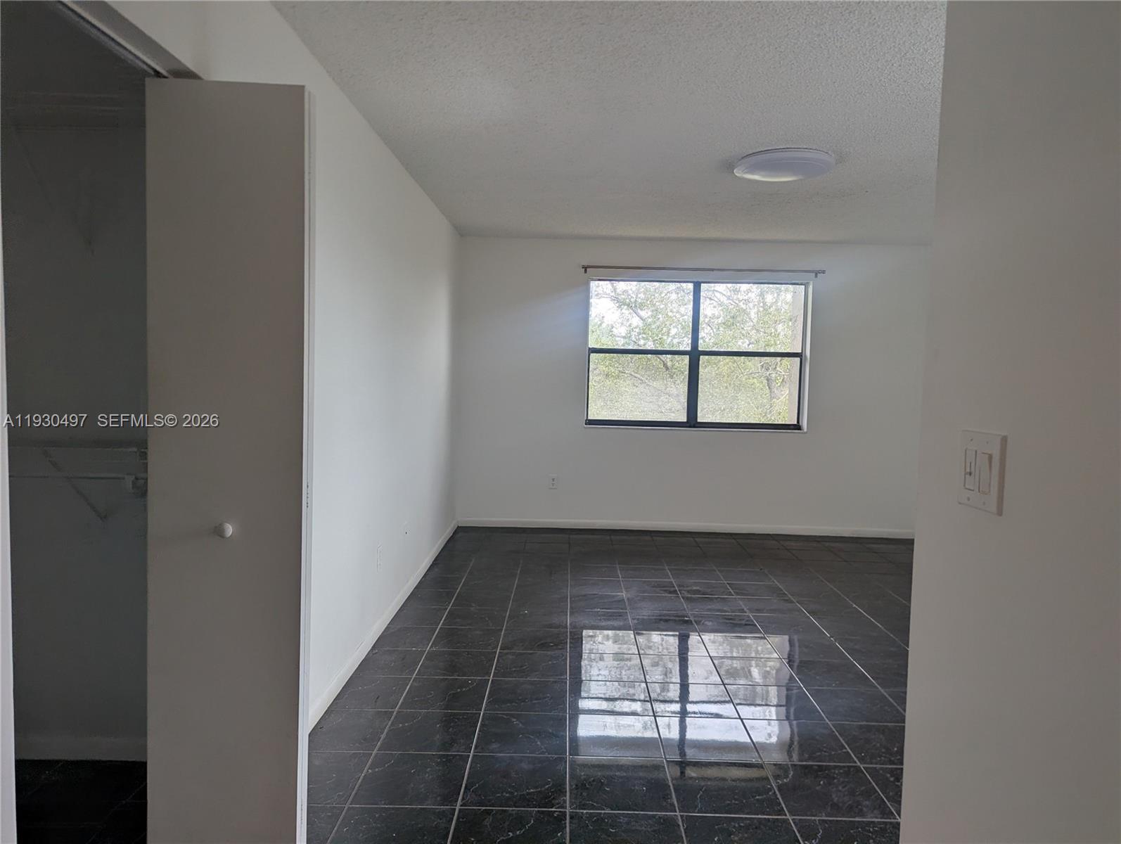 601 Ives Dairy Road, Unit 4058 Miami, FL 33179 - Photo 9 of 21 an empty room with windows