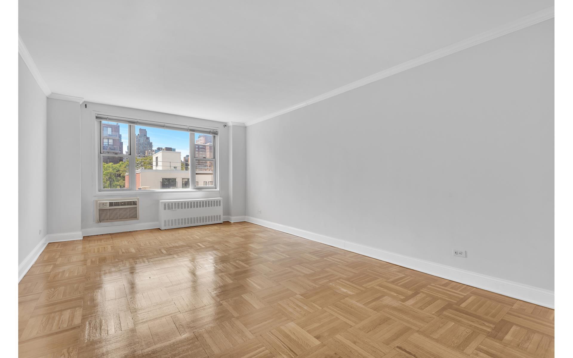 435 East 77th Street, Unit 8F Manhattan, NY 10075 - Photo 6 of 8 a view of a kitchen with wooden floor and a window