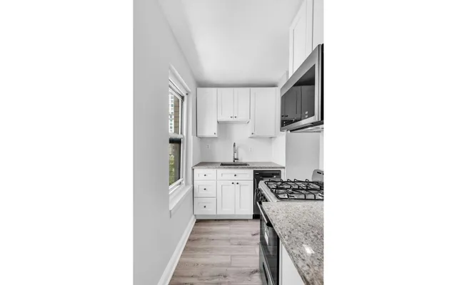 a kitchen with stainless steel appliances granite countertop a sink and cabinets