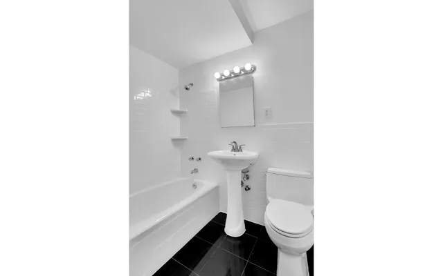 a bathroom with a sink toilet and bathtub