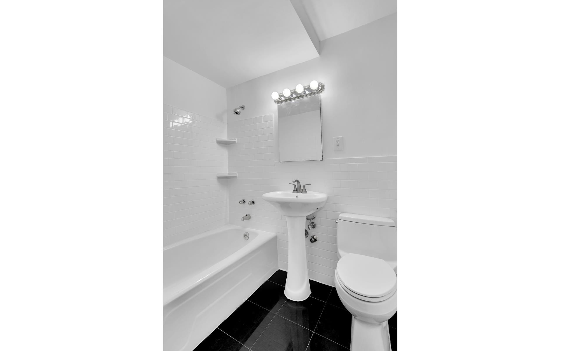 435 East 77th Street, Unit 8F Manhattan, NY 10075 - Photo 8 of 8 a bathroom with a sink toilet and bathtub