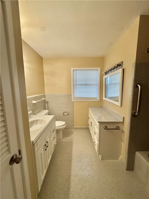 614 Dolphin Place Corpus Christi, TX 78411 - Photo 11 of 23 a bathroom with a granite countertop sink toilet and shower